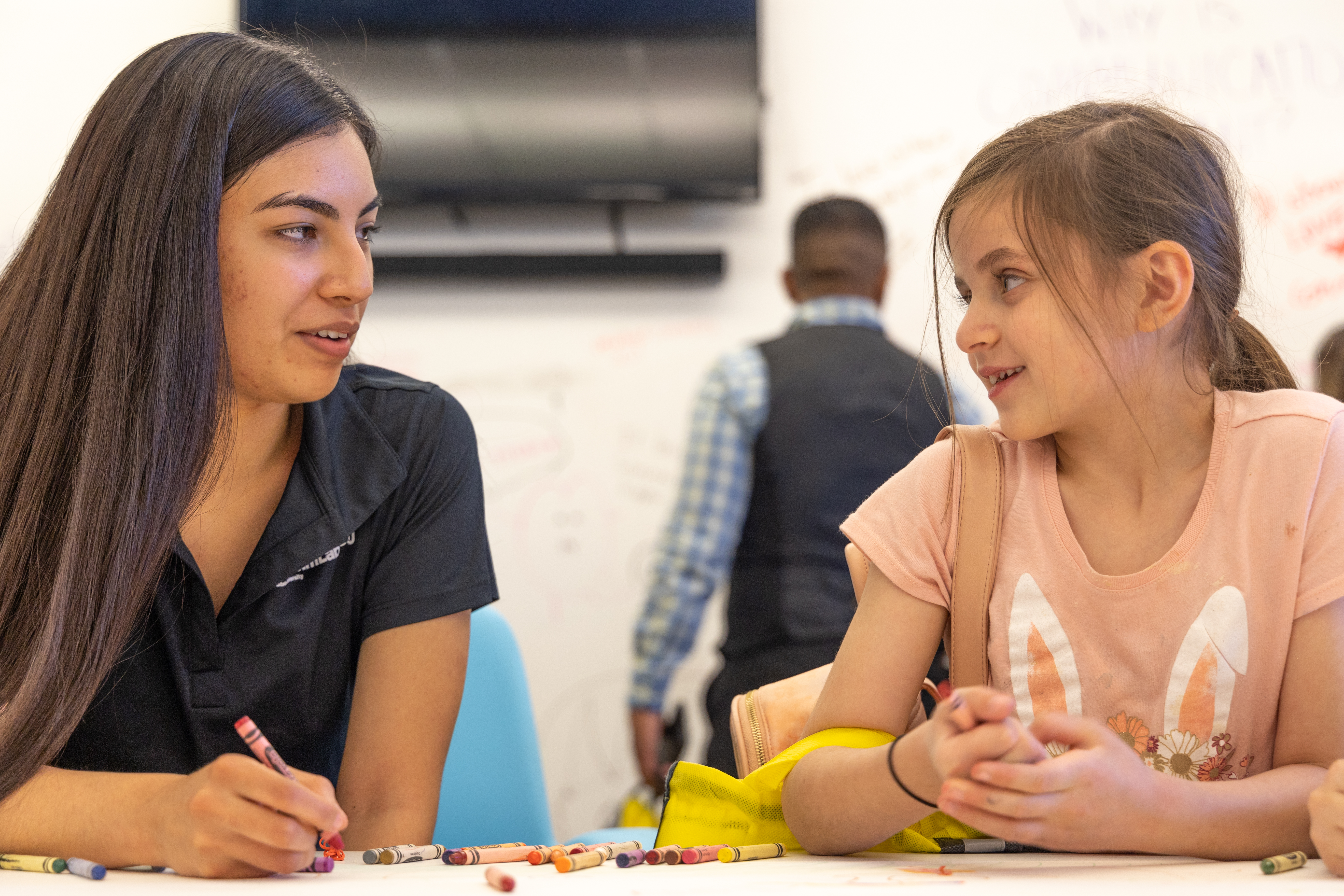 ASU student and elementary student talking